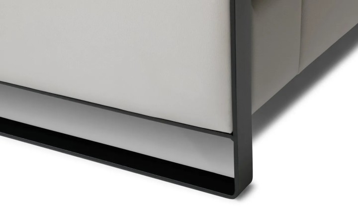 Side view of the Mayon corner sofa – featuring a sleek metal leg and elegant backrest in a modern style.