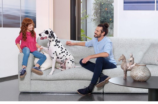 Family with a dog enjoying an AquaClean sofa
