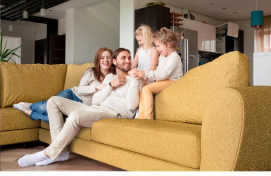 Family relaxing together on a yellow AquaClean sofa